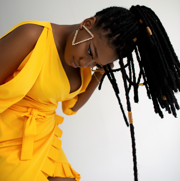 Beautiful woman in a yellow dress with braids